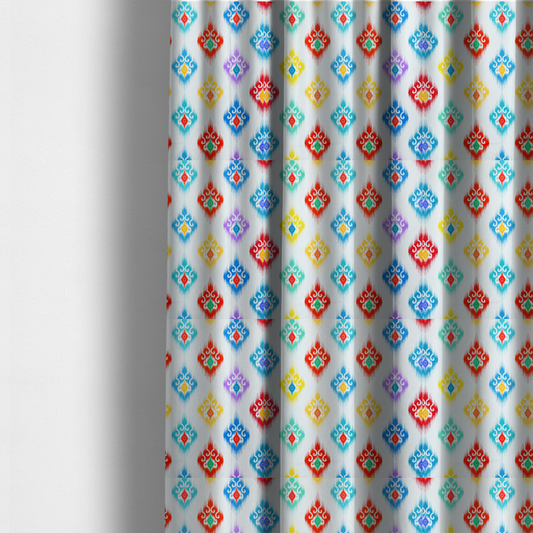 The fabric used to create these made-to-measure curtains is a colourful, patterned textile with an ikat-style design and repeating diamond motifs.