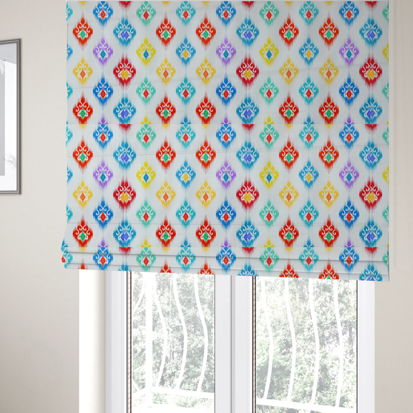 The fabric used to create these Roman blinds is a colourful, patterned textile with an ikat-style design and repeating diamond motifs.