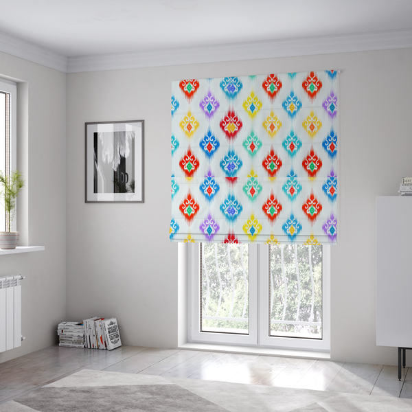 The fabric used to create these Roman blinds is a colourful, patterned textile with an ikat-style design and repeating diamond motifs.