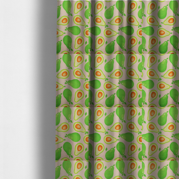 The fabric used to create these made-to-measure curtains is a repeating pattern fabric featuring whimsical illustrations of whole green avocados with small leaves and sliced avocado halves showing bright orange pits, all scattered across a light pink background.