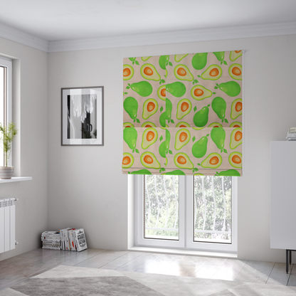 The fabric used to create these roman blinds is a repeating pattern fabric featuring whimsical illustrations of whole green avocados with small leaves and sliced avocado halves showing bright orange pits, all scattered across a light pink background.