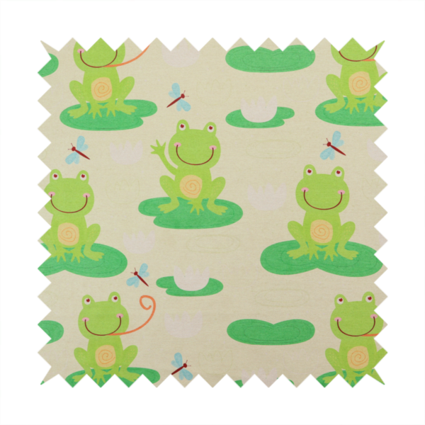 A repeating pattern fabric featuring cute cartoon green frogs sitting on bright green lily pads, interspersed with blue and red dragonflies and white water lilies on a light cream background.