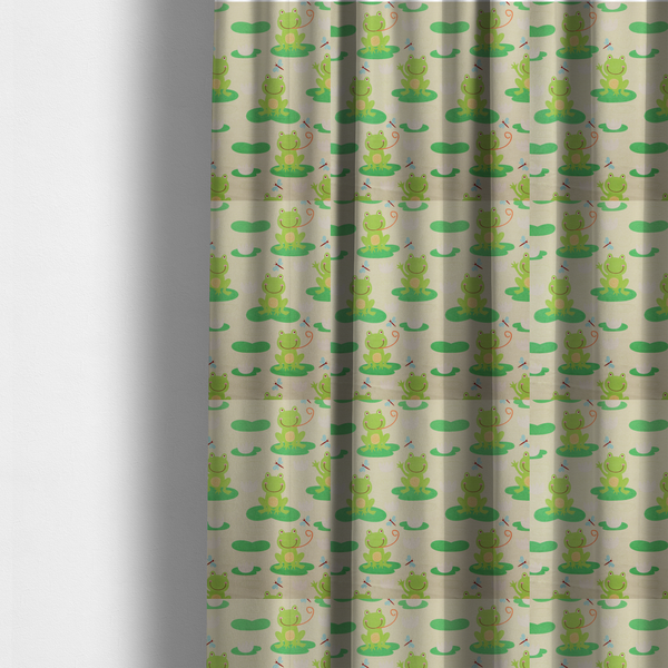 The fabric used to create these made-to-measure curtains is a repeating pattern fabric featuring cute cartoon green frogs sitting on bright green lily pads, interspersed with blue and red dragonflies and white water lilies on a light cream background.