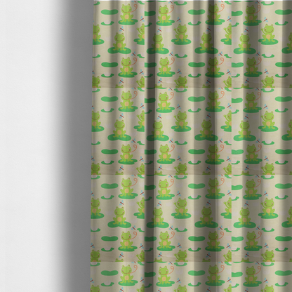 The fabric used to create these made-to-measure curtains is a repeating pattern fabric featuring cute cartoon green frogs sitting on bright green lily pads, interspersed with blue and red dragonflies and white water lilies on a light cream background.