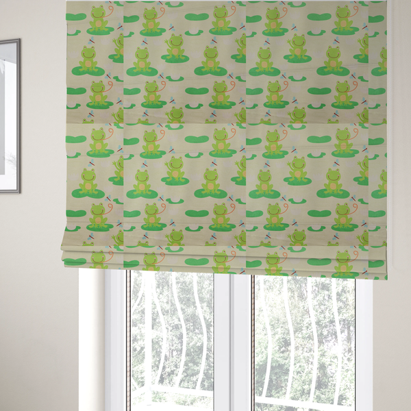 The fabric used to create these Roman blinds is a repeating pattern fabric featuring cute cartoon green frogs sitting on bright green lily pads, interspersed with blue and red dragonflies and white water lilies on a light cream background.