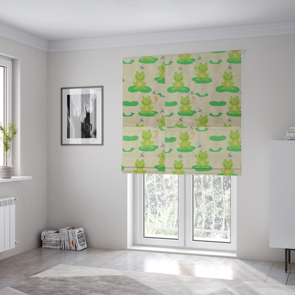 The fabric used to create these Roman blinds is a repeating pattern fabric featuring cute cartoon green frogs sitting on bright green lily pads, interspersed with blue and red dragonflies and white water lilies on a light cream background.