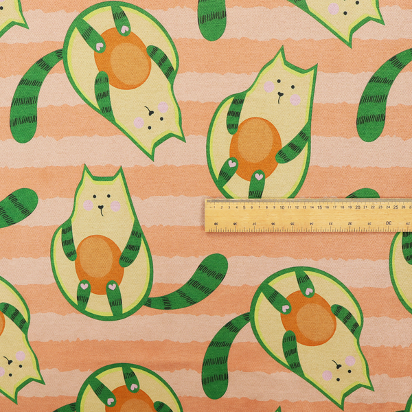 A playful repeating pattern fabric featuring whimsical illustrated "avocatos"—cats shaped like avocado halves with green striped tails and orange pits—over a light peach background with horizontal orange stripes.