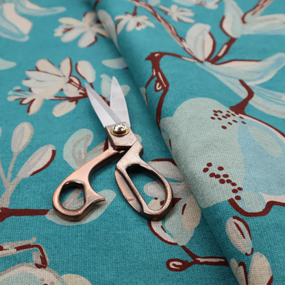 A botanical fabric design with trailing branches adorned with oval citrus fruit motifs, leaves, and small blossoms.