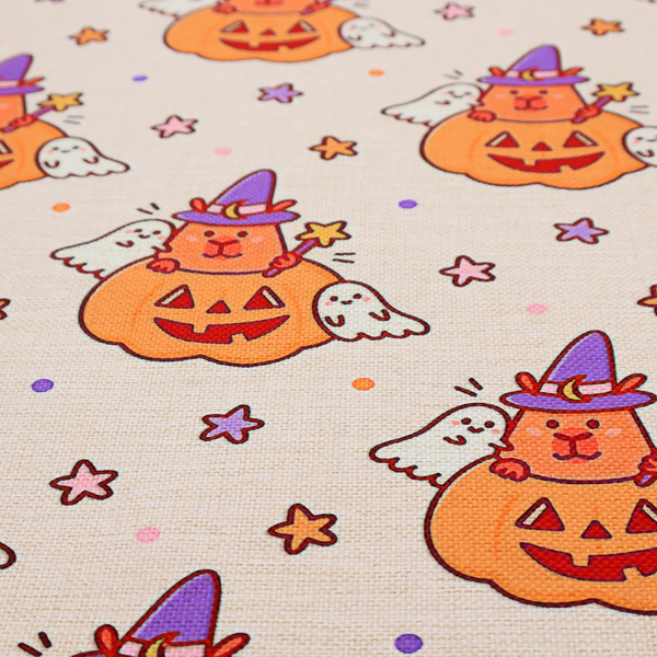 A seamless, repeating Halloween-themed pattern featuring cute capybaras dressed as witches with purple hats and holding magic star wands, peeking out of carved jack-o'-lantern pumpkins, accompanied by friendly little ghosts, orange and purple stars, and polka dots on a light fabric-textured background.