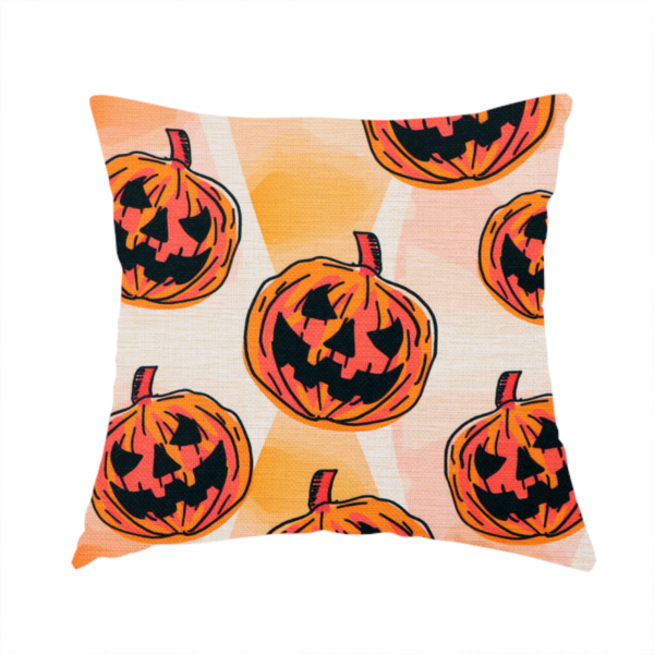 The fabric used to create this handmade cushion is a seamless, repeating Halloween-themed pattern featuring vibrant orange carved jack-o'-lantern pumpkins with bold, black spooky expressions and lined details set against an abstract geometric orange and cream background.