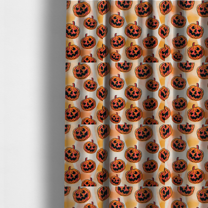 The fabric used to create these made-to-measure curtains is a seamless, repeating Halloween-themed pattern featuring vibrant orange carved jack-o'-lantern pumpkins with bold, black spooky expressions and lined details set against an abstract geometric orange and cream background.
