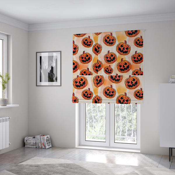 The fabric used to create these Roman blinds is a seamless, repeating Halloween-themed pattern featuring vibrant orange carved jack-o'-lantern pumpkins with bold, black spooky expressions and lined details set against an abstract geometric orange and cream background.