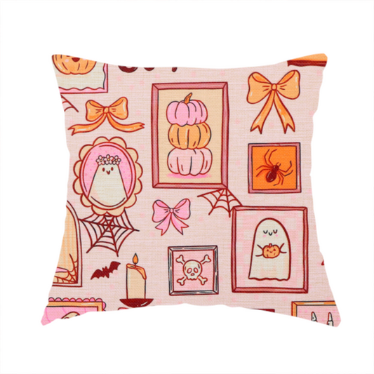 The fabric being used to create this handmade cushion is a seamless, repeating Halloween-themed pattern featuring a pink gallery wall filled with framed art, including cute ghosts, stacked pumpkins, a witch hat, a "Spooky Season" sign, bats, mushrooms, bows, spiderwebs, candles, and a skeletal peace sign hand on a light pink textured background.