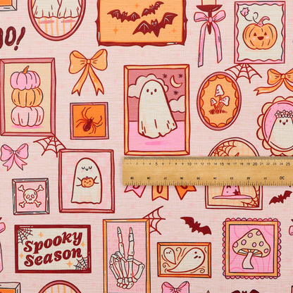 A seamless, repeating Halloween-themed pattern featuring a pink gallery wall filled with framed art, including cute ghosts, stacked pumpkins, a witch hat, a "Spooky Season" sign, bats, mushrooms, bows, spiderwebs, candles, and a skeletal peace sign hand on a light pink textured background.