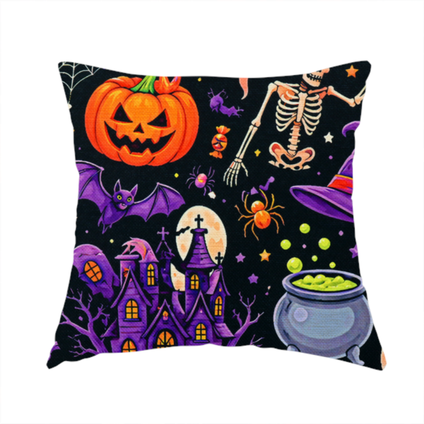 The fabric used to create this handmade cushion is a seamless, repeating Halloween-themed pattern featuring a spooky black background crowded with a haunted purple house, a dancing skeleton, a boiling cauldron with green potion, smiling jack-o'-lantern pumpkins, friendly ghosts, a purple witch hat, a purple cat, flying bats, spiders, spiderwebs, candy, and colourful stars.