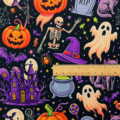A seamless, repeating Halloween-themed pattern featuring a spooky black background crowded with a haunted purple house, a dancing skeleton, a boiling cauldron with green potion, smiling jack-o'-lantern pumpkins, friendly ghosts, a purple witch hat, a purple cat, flying bats, spiders, spiderwebs, candy, and colourful stars.