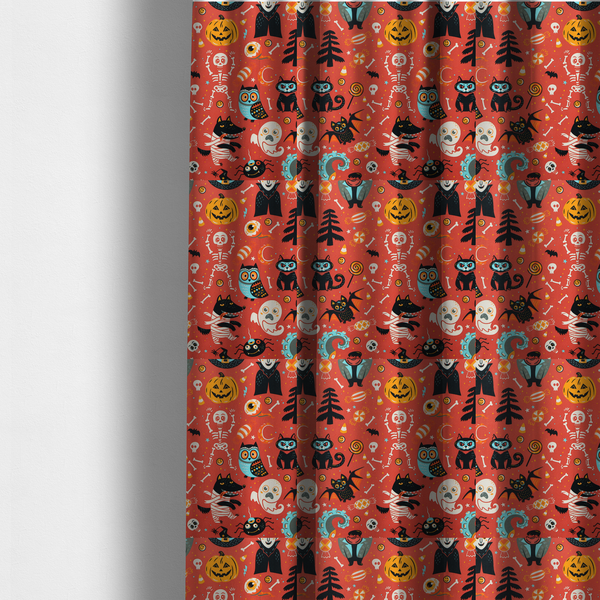 The fabric used to create these made-to-measure curtains is a seamless, repeating Halloween-themed pattern featuring a vibrant red-orange background filled with a dancing skeleton, vampires, a mummified dog, a blue owl, black cats, a flying bat, ghosts, a jack-o'-lantern, candy, skulls, trees, and whimsical monsters.