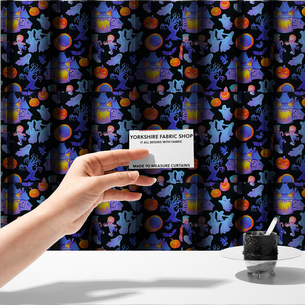 The fabric used to create these made-to-measure curtains is a seamless, repeating Halloween-themed pattern featuring a black background filled with glowing blue haunted houses, flying ghosts, orange jack-o'-lanterns, gnarled trees, bats, a crescent moon, and fleeing children.