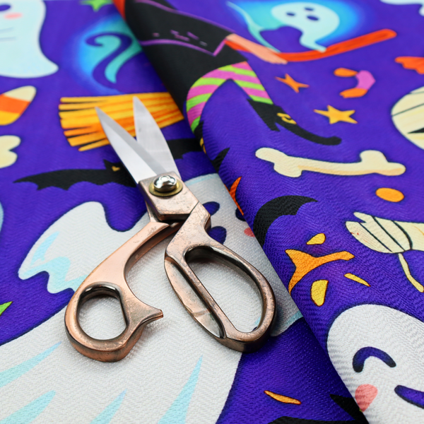 A seamless, repeating Halloween-themed pattern featuring a vibrant purple background filled with a witch riding a broomstick with a black cat, a mummified figure, ghosts, bats, a tombstone, bones, candy, and stars.