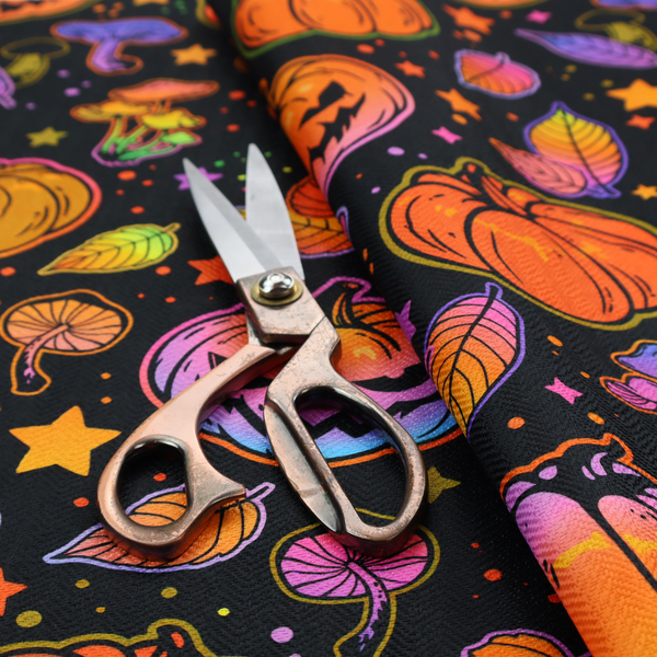 A seamless, repeating Halloween and autumn-themed pattern featuring a black background filled with colourful carved jack-o'-lanterns, pumpkins, mushrooms, autumn leaves, and glowing stars.
