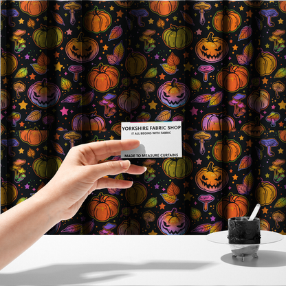 The fabric used to create these made-to-measure curtains is a seamless, repeating Halloween and autumn-themed pattern featuring a black background filled with colourful carved jack-o'-lanterns, pumpkins, mushrooms, autumn leaves, and glowing stars.