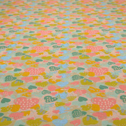 A colourful repeating pattern of overlapping hearts in shades of pink, teal, yellow, and blue, set against a textured background.