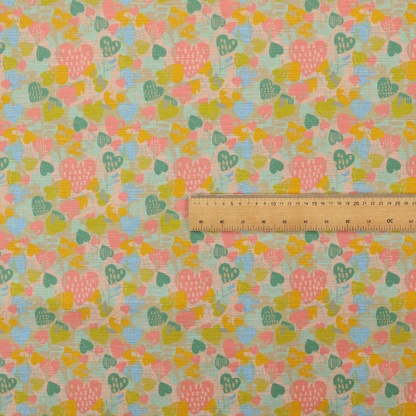 A colourful repeating pattern of overlapping hearts in shades of pink, teal, yellow, and blue, set against a textured background.