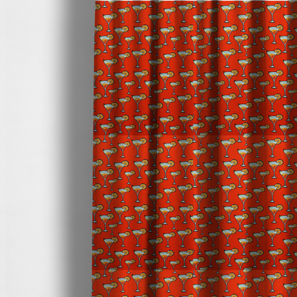 The fabric used to create these made-to-measure curtains is a repeating pattern of cocktail glasses filled with orange liquid, garnished with a slice of orange and a cherry, set against a bright red background.