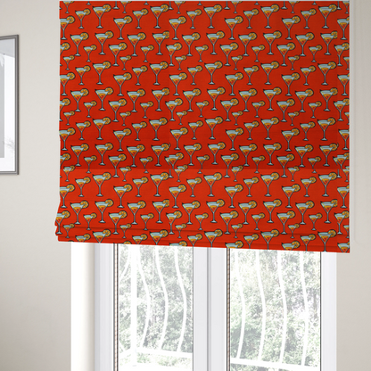 The fabric used to create these Roman blinds is a repeating pattern of cocktail glasses filled with orange liquid, garnished with a slice of orange and a cherry, set against a bright red background.