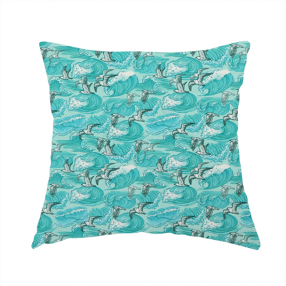 The fabric used to create this handmade cushion is a repeating pattern of crashing ocean waves and soaring seagulls rendered in shades of teal and white.
