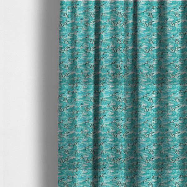 The fabric used to create these made-to-measure curtains is a repeating pattern of crashing ocean waves and soaring seagulls rendered in shades of teal and white.