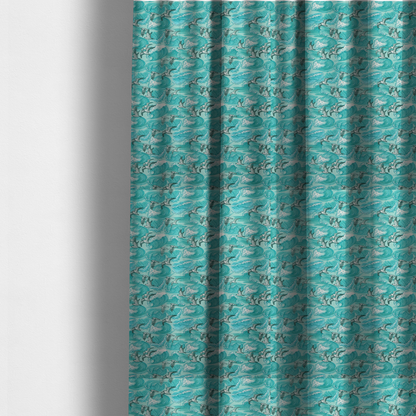 The fabric used to create these made-to-measure curtains is a repeating pattern of crashing ocean waves and soaring seagulls rendered in shades of teal and white.