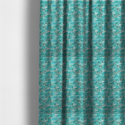 The fabric used to create these made-to-measure curtains is a repeating pattern of crashing ocean waves and soaring seagulls rendered in shades of teal and white.