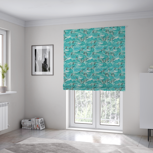 The fabric used to create these Roman blinds is a repeating pattern of crashing ocean waves and soaring seagulls rendered in shades of teal and white.
