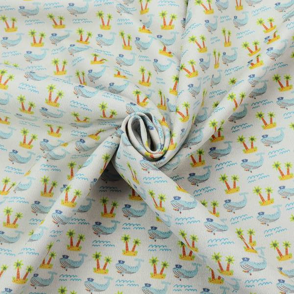 A repeating pattern of small blue whales wearing captain's hats swimming near tiny tropical islands with palm trees, set against a light grey background with small blue wave lines.