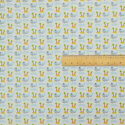 A repeating pattern of small blue whales wearing captain's hats swimming near tiny tropical islands with palm trees, set against a light grey background with small blue wave lines.
