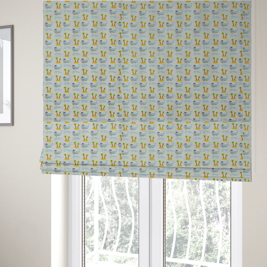 The fabric used to create these Roman blinds is a repeating pattern of small blue whales wearing captain's hats swimming near tiny tropical islands with palm trees, set against a light grey background with small blue wave lines.