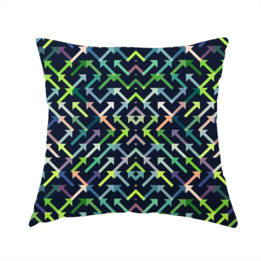The fabric used to create this handmade cushion is a geometric repeating pattern of intersecting lines and arrows in shades of green, blue, and peach, set against a dark navy background.