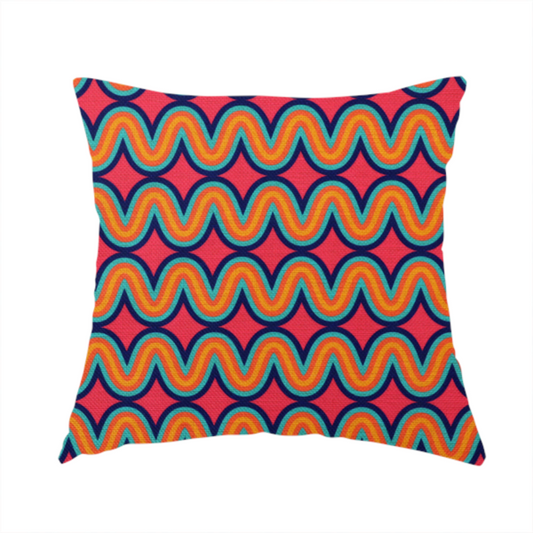 The fabric used to create this handmade cushion is a repeating geometric pattern of undulating, concentric wavy lines in teal, orange, and yellow, outlined in dark blue, set against a vibrant pink background.