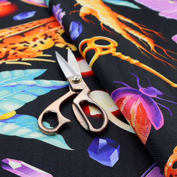 A vibrant, repeating mystical pattern on a black background featuring illustrated mandrake roots with faces, orange frogs, purple moths, glowing fireflies, potion bottles filled with eyeballs, ornate golden keys, luminescent mushrooms, lavender sprigs, and scattered crystals.
