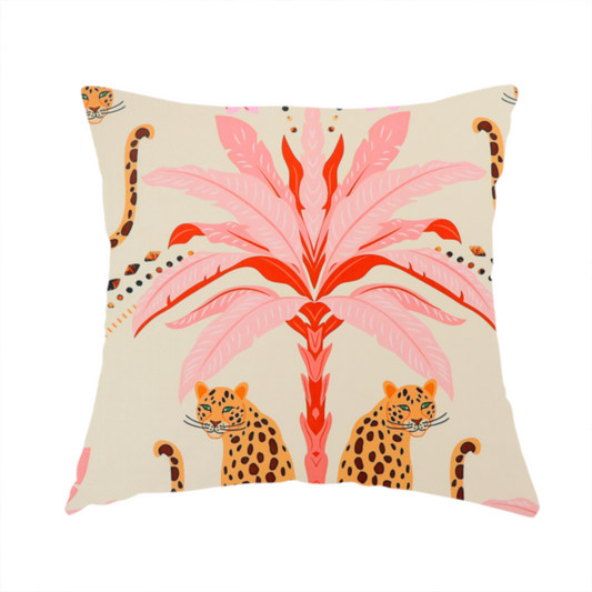 The fabric used to create this handmade cushion is a symmetrical, repeating tropical pattern on a light background featuring stylized leopards sitting below bright pink and red palm trees, accented with pink flowers, green foliage, and geometric dotted arches.