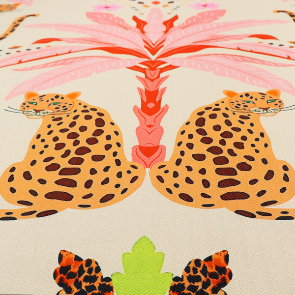 A symmetrical, repeating tropical pattern on a light background featuring stylized leopards sitting below bright pink and red palm trees, accented with pink flowers, green foliage, and geometric dotted arches.