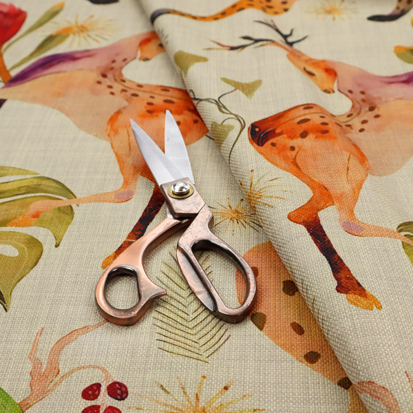 A symmetrical, illustrative pattern featuring spotted leopards, leaping deer, large red flowers, green parrots, monstera leaves, and starburst details on a light background.