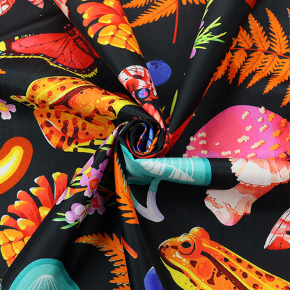 A vibrant, repeating botanical pattern on a black background featuring bright red butterflies, orange spotted frogs, orange pinecones, pink and white mushrooms, orange fern fronds, blue berries, and purple wildflowers.