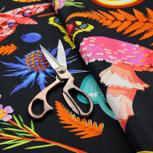 A vibrant, repeating botanical pattern on a black background featuring bright red butterflies, orange spotted frogs, orange pinecones, pink and white mushrooms, orange fern fronds, blue berries, and purple wildflowers.