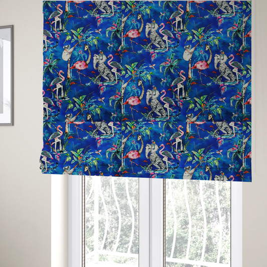 The fabric used to create these Roman blinds is a whimsical tropical pattern featuring colourful flamingos, giraffes, leopards, elephants, and koalas amidst lush foliage on a vibrant blue background.