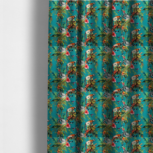 The fabric used to create these made-to-measure curtains is a playful tropical pattern featuring ring-tailed lemurs, hummingbirds, and exotic flowers amongst lush green foliage on a bright turquoise background.