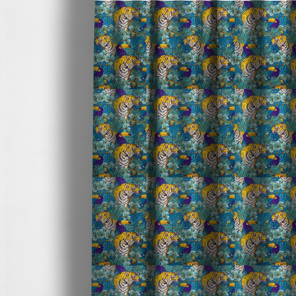 The fabric used to create these made-to-measure curtains is a vibrant tropical pattern featuring majestic tigers, toucans, and exotic flowers amongst lush green foliage on a bold blue background.  