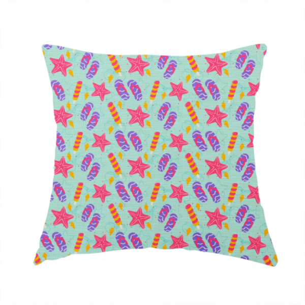 The fabric used to create this handmade cushion is a playful summer pattern featuring pink starfish, flip-flops, and striped popsicles set against a light turquoise background.