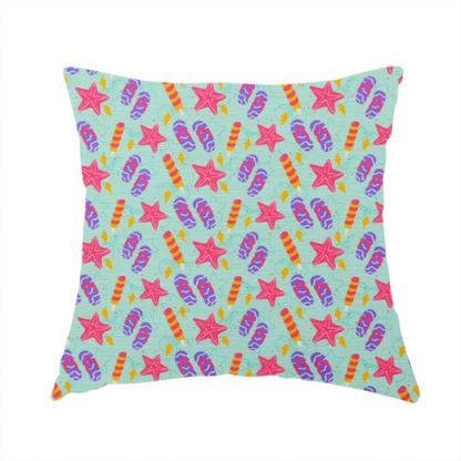 The fabric used to create this handmade cushion is a playful summer pattern featuring pink starfish, flip-flops, and striped popsicles set against a light turquoise background.